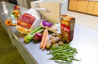 A table with food and vegetables on it.