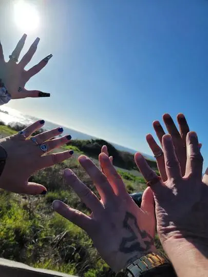 A group of people with their hands up in the air.